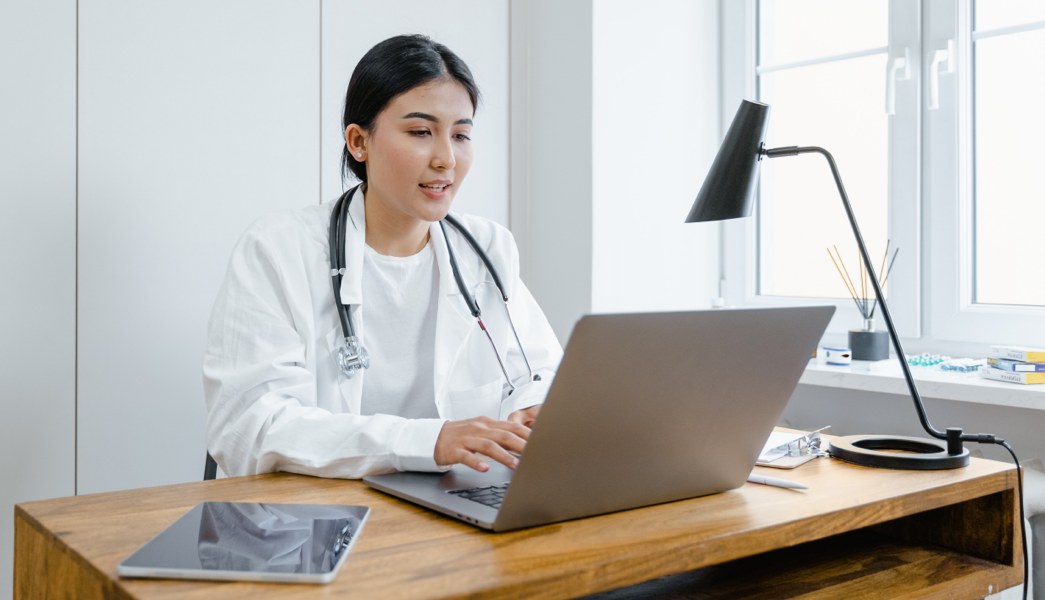 Doctor looking at a computer typing